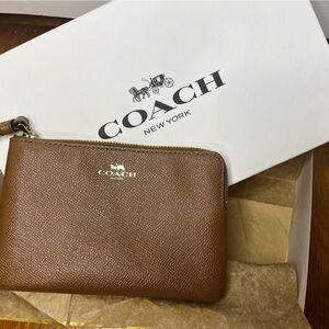 NWOT- Coach wristlet that comes with genuine coach gift box.  6” x 4”